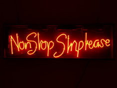 non stop strip tease red neon sign
